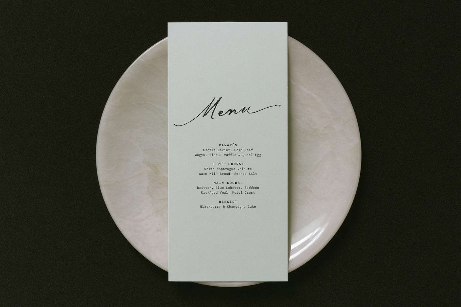 Midnight Symphony script on a menu card with gold accents
